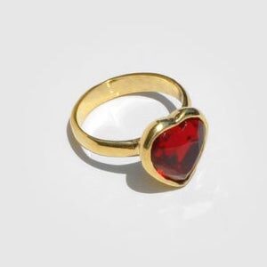 Brass ring with red heart-shaped glass ruby
