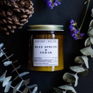 Candle surrounded by wildflowers