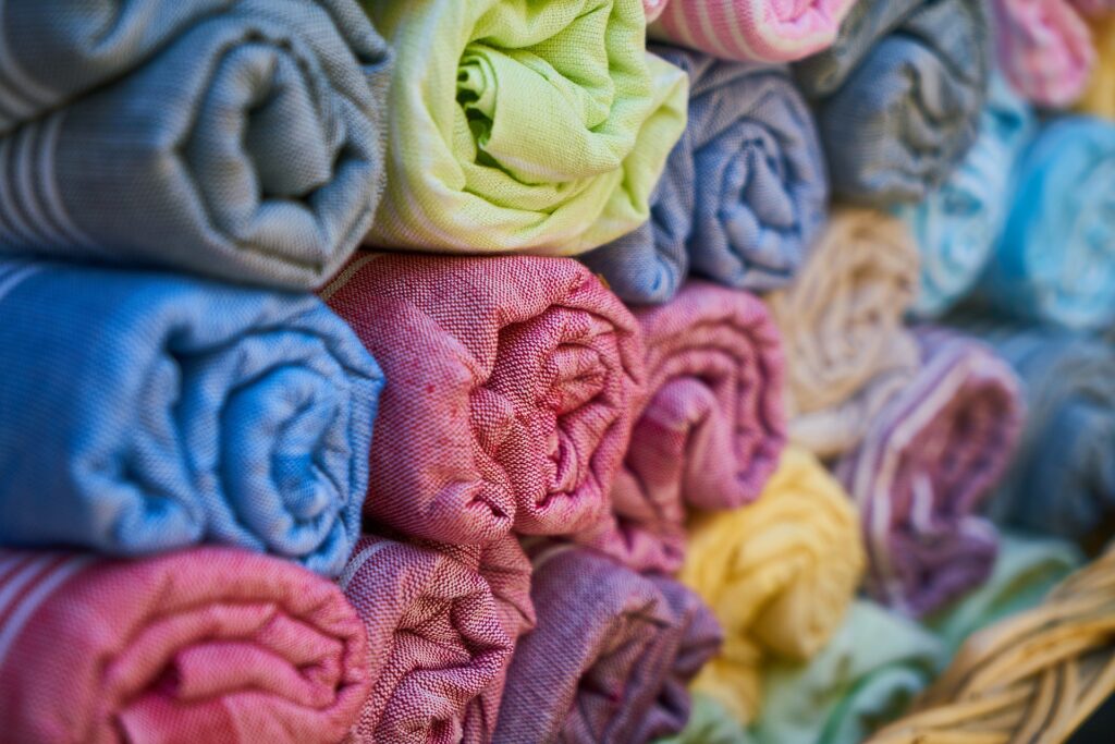 Stacked multicolored rolls of fabric