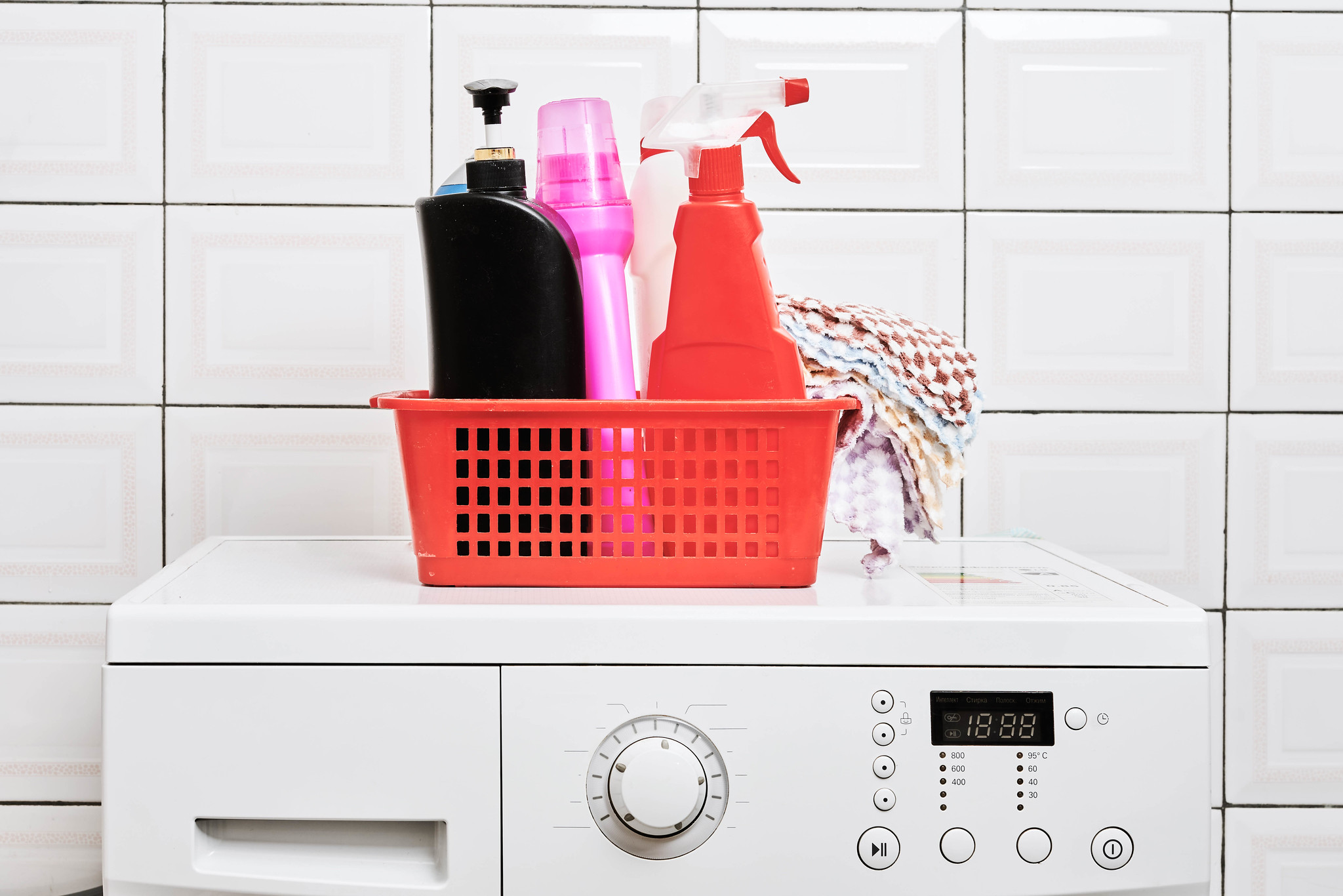 Basket of laundry products on washing machine