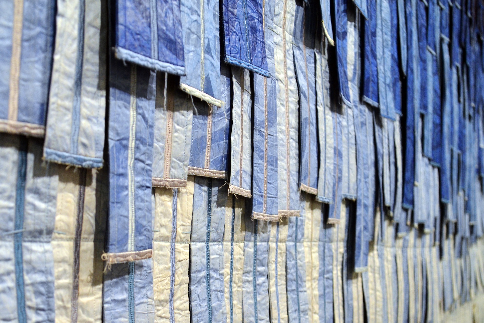 Blue fabric strips hanging on a wall