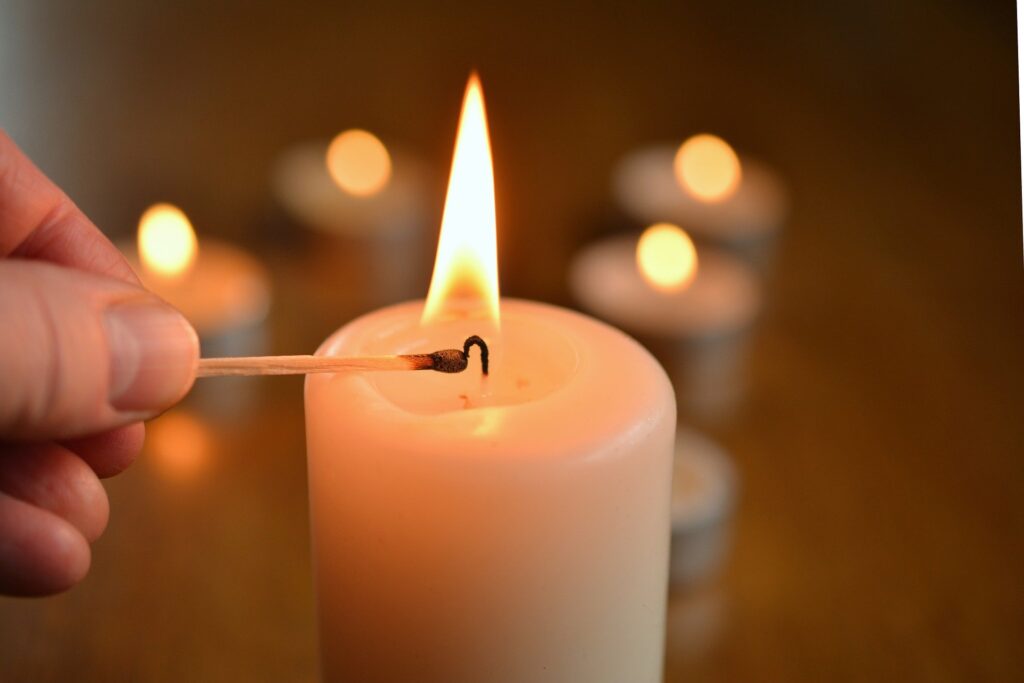 Close-up of person lighting candle with a match