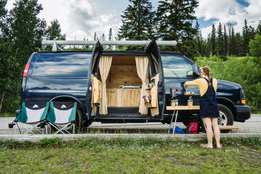 woman cooking outside her van