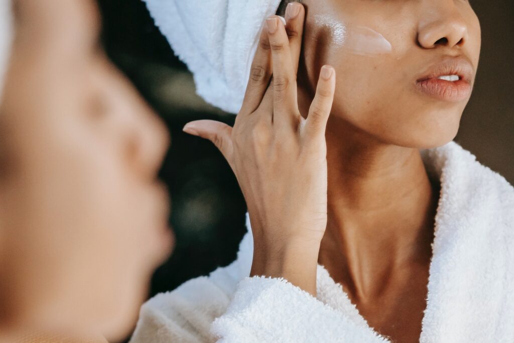 woman putting face lotion on