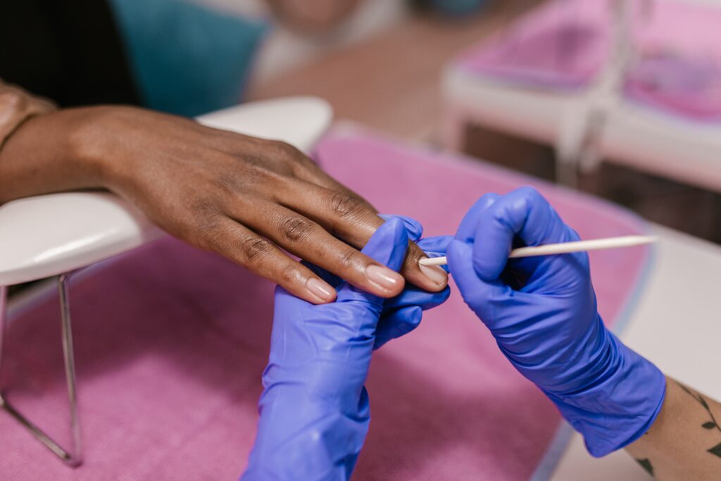 woman's hands getting manicure